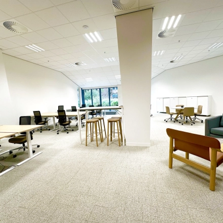Spacious, well-lit office for rent at Bijlmerplein 888 in Amsterdam South East, featuring modern furnishings and an open work area with desks, chairs, and seating options.