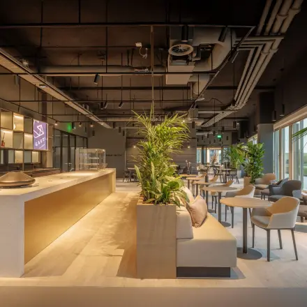 Modern furnished office space with seating area and natural light in Amsterdam South East, ideal for office space rental.