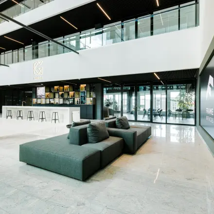 Modern office entrance with seating and a sleek design at Herikerbergweg 290, ideal for office space rental in Amsterdam South East.