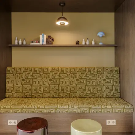 Cozy nook with patterned seating and shelves at Herikerbergweg 290, ideal for office space rental in Amsterdam South East.