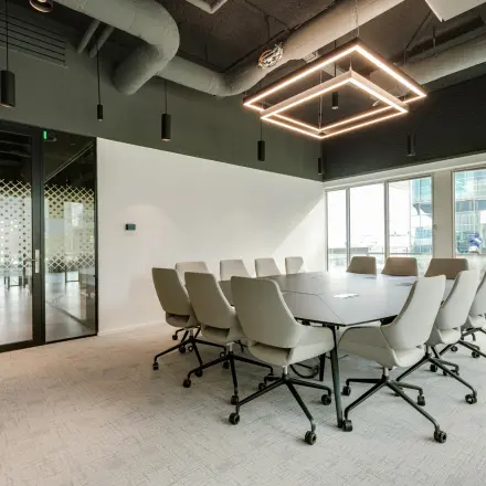 Modern furnished conference room at Herikerbergweg 290, Amsterdam South East, ideal for office space rental with a sleek design and large table.