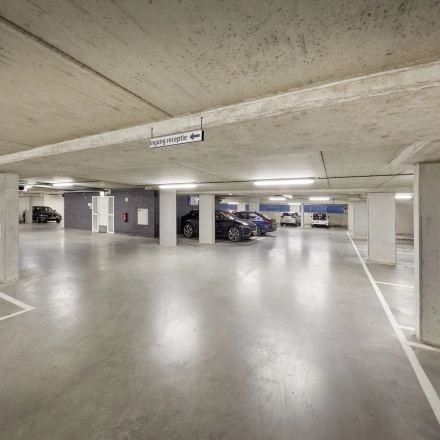 Spacious parking area at Hogehilweg 24, perfect for those seeking secure office space rental in Amsterdam South East. Multiple cars are parked neatly, offering ample space for vehicle accommodation.
