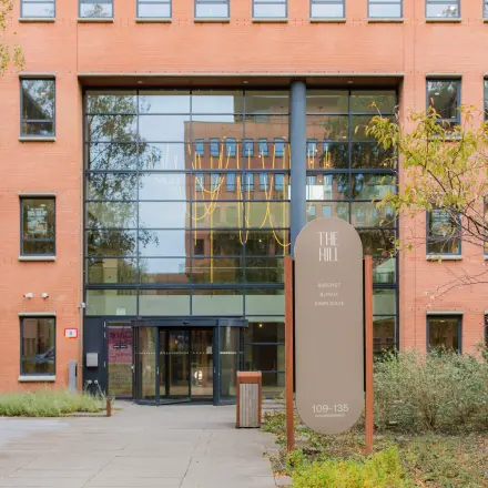 Exterior view of the office building at Hullenbergweg 109-135 in Amsterdam South East, showcasing a modern entrance suitable for office space rental.