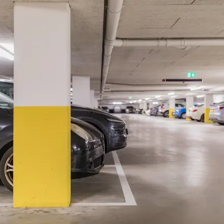 Underground parking area at Hullenbergweg 109-135, Amsterdam South East, with several cars parked and clear signages.