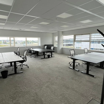 Spacious office at Laarderhoogtweg 7-19, Amsterdam South East, available for rent. Furnished with modern desks and chairs, ideal for collaborative work. Large windows offer ample natural light.