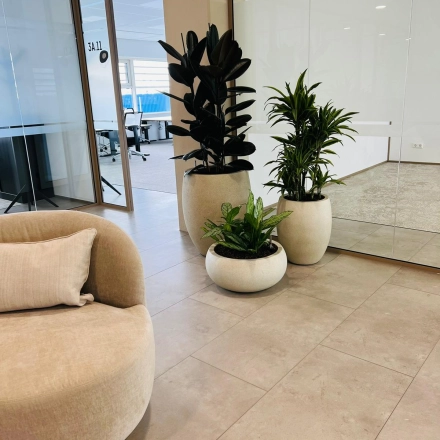 Modern office lobby at Laarderhoogtweg 7-19, Amsterdam South East, featuring stylish seating and indoor plants. Ideal office space rental opportunity.