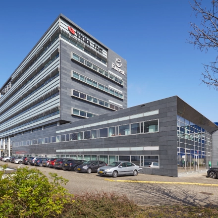 Exterior view of office to rent at Laarderhoogtweg 7-19 in Amsterdam South East, showing the modern architecture and ample parking space for office space rental.