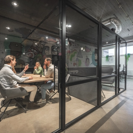 Office space at Luttenbergweg 8, Amsterdam South East with people in a meeting room. Ideal for office space rental.