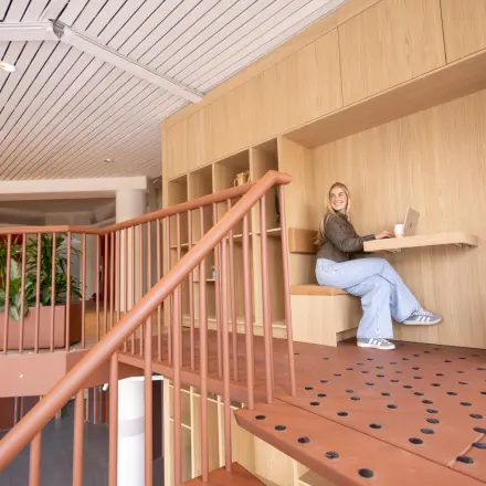 Modern workspace at Luttenbergweg 8, Amsterdam South East, featuring stylish wooden elements and a professional working environment. Ideal for office space rental with available offices to rent.