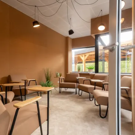 Cozy office space with modern furnishings at Luttenbergweg 8, Amsterdam South East, available for rent. Comfortable seating and natural lighting create a welcoming environment.