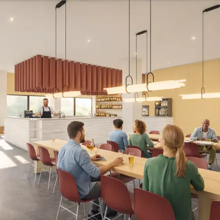 Professionals seated at long tables in a well-lit, modern lounge at the Luttenbergweg 8 office in Amsterdam South East, ideal for rent office space.