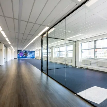Office space for rent at Paasheuvelweg 20 20 in Amsterdam South East, featuring spacious interiors with large windows and glass walls.