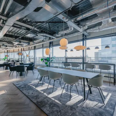 Modern conference room with large windows and stylish lighting at Bos en Lommerplein 280, ideal for office space rental in Amsterdam West.