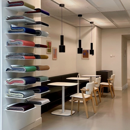 Modern office space in Amsterdam West featuring a furnished seating area with tables and chairs, ideal for office space rental.