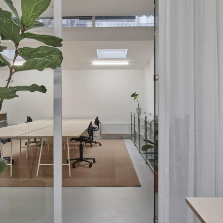 Modern office space with minimalist design at Hondiusstraat 7H, Amsterdam West. Features include sleek desks, contemporary chairs, and natural lighting, ideal for office space rental.