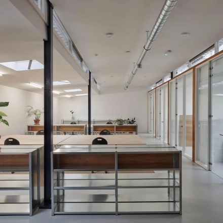 Bright office interior at Hondiusstraat 7H, Amsterdam West, showcasing modern, airy workspaces with sleek desks and large windows, ideal for office space rental.