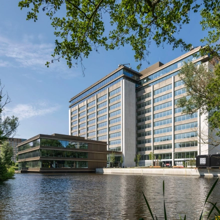Modern office building at Nachtwachtlaan 20, Amsterdam West, featuring large windows and surrounded by greenery, ideal for office space rental.