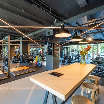 Modern gym area in an office space with various fitness equipment. Ideal for office space rental to encourage employee wellness at Nachtwachtlaan 20, Amsterdam West.