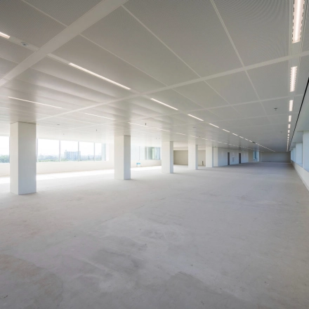 Office space for rent at Nachtwachtlaan 20, Amsterdam West. Spacious, unfurnished interior with large windows providing natural light, ideal for various office setups.