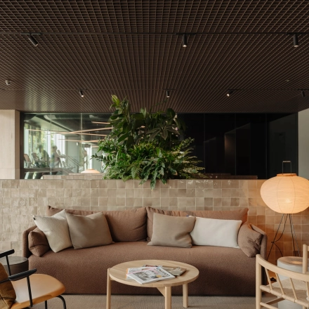 Cozy and modern lounge area with seating and table, ideal for office space rental at Nachtwachtlaan 20, Amsterdam West.