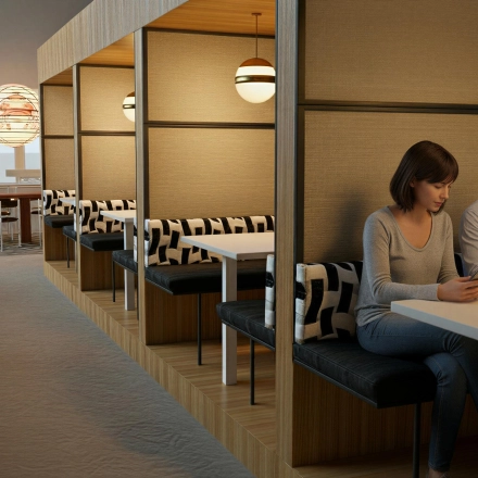 Cozy office space rental at Barbara Strozzilaan 101 101 in Amsterdam Zuidas, featuring booth seating with two people engaged in business activities.