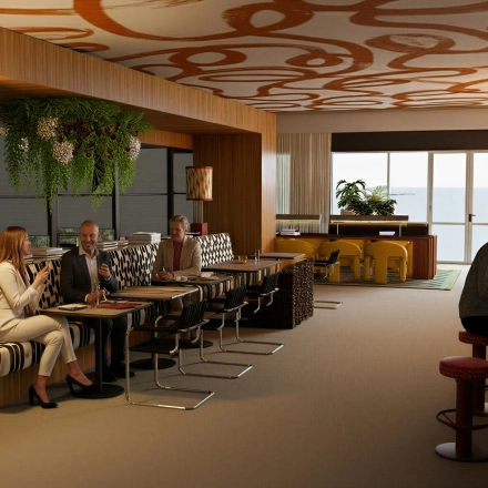Modern office space at Barbara Strozzilaan 101 101 in Amsterdam Zuidas, featuring professionals collaborating in a stylish lounge area with seating and computer stations perfect for office space rental.