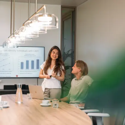 Professionals engaged in a discussion around a conference table at Beethovenstraat 503, Amsterdam Zuidas, ideal for office space rental.