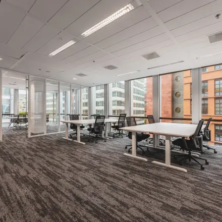 Spacious office interior at Claude Debussylaan 10 in Amsterdam Zuidas with modern furnishings and large windows, ideal for office space rental.