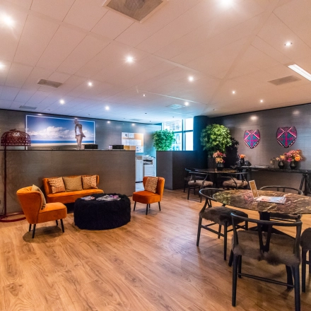 Modern office space in Amsterdam Zuidas at Claude Debussylaan 7-29, featuring stylish furniture and vibrant decor, ideal for office space rental.