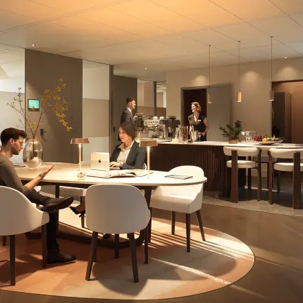 Modern furnished workspace with people engaged in business activities, including meetings and discussions, ideal for office space rental at Claude Debussylaan 80-134, Amsterdam Zuidas.