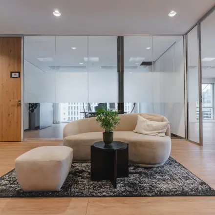 Furnished office interior at De Boelelaan 30, Amsterdam Zuidas, featuring modern seating and table. Ideal for office space rental.