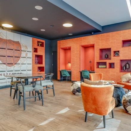 Stylish office space rental at Gustav Mahlerlaan 308, Amsterdam Zuidas with vibrant seating and modern decor, ideal for professional use.
