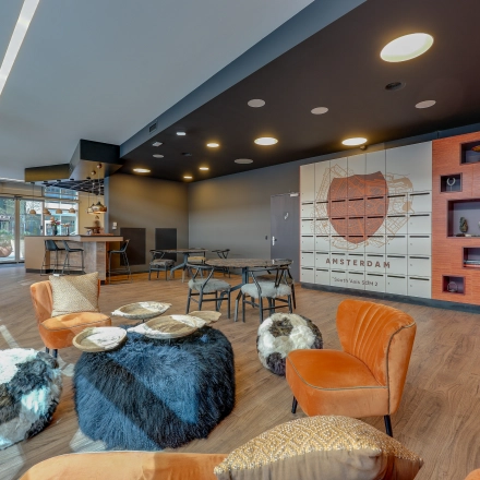 Modern furnished office space rental with cozy seating and decor at Gustav Mahlerlaan 308, Amsterdam Zuidas.
