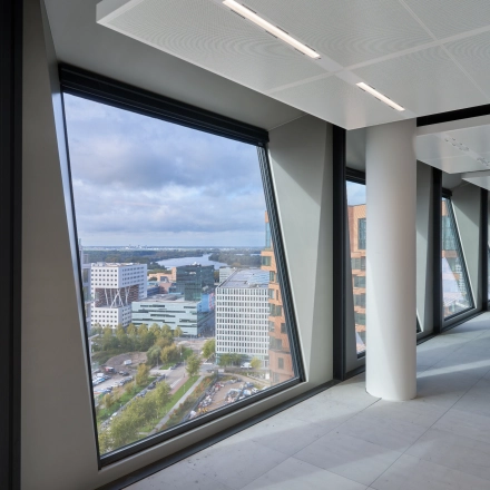 Spacious office in Amsterdam Zuidas, featuring large windows with impressive city views. Ideal for office space rental.