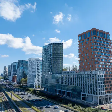 Skyline view of Amsterdam Zuidas with modern architecture, showcasing potential office space rentals in the area.