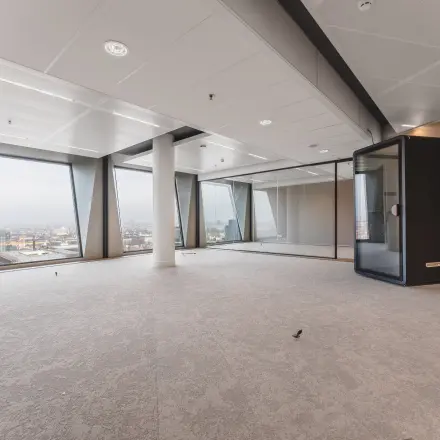 Spacious office space at Hildegard Von Bingenstraat 44 in Amsterdam Zuidas, featuring large windows and neutral decor, ideal for office space rental.