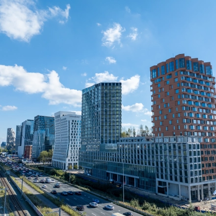 Exterior view of modern office buildings in Amsterdam Zuidas, showcasing potential office space rental at Hildegard Von Bingenstraat 44.