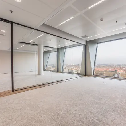 Bright office space at Hildegard Von Bingenstraat 44 in Amsterdam Zuidas, featuring large windows and glass partitions, available for office space rental.