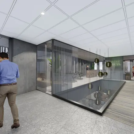 Business professionals interact in a modern office space in Amsterdam Zuidas, located at Jachthavenweg 109, showcasing office space rental opportunities with contemporary furnishings.