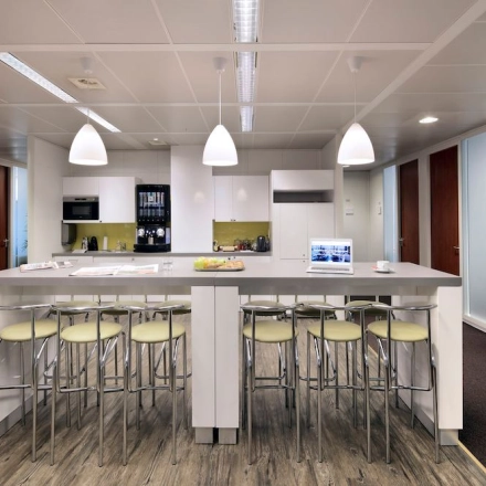 Modern office kitchen space at Lange Lozanastraat 142 in Antwerp Center, featuring a sleek counter with bar stools, ideal for office space rental.