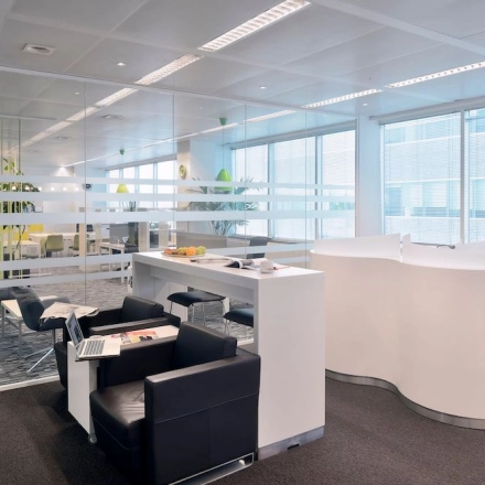 Modern office space in Antwerp with sleek furniture and glass partitions, ideal for business activities. Find office space rental opportunities here.