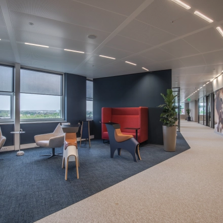 Modern office space for rent at Rijksweg-West 2, Arnhem Zuid, featuring comfortable seating areas with stylish chairs and large windows offering natural light.