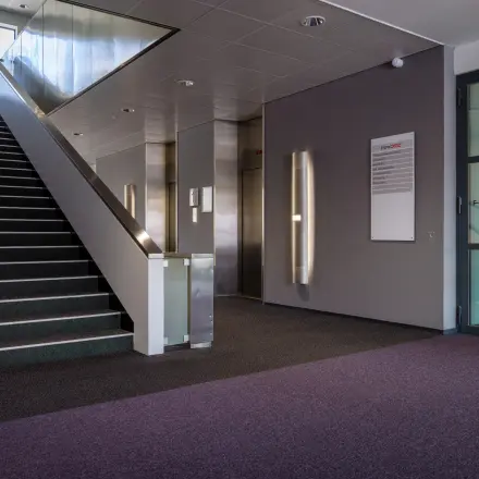 Interior view of the office entrance at Amalialaan 126, Baarn with stairs and elevator access, ideal for office space rental.