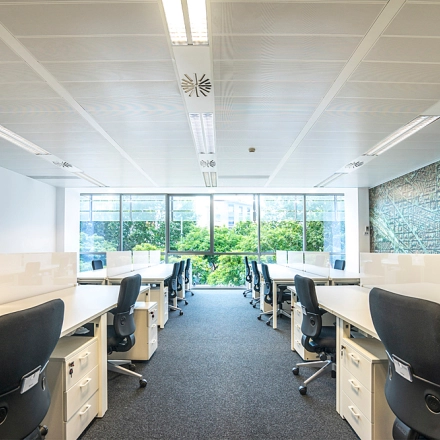Bright, well-lit office space with rows of desks and ergonomic chairs, ideal for office space rental at Carrer de Llull 321, Barcelona @22.