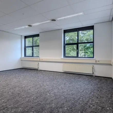 Spacious, well-lit office space with large windows at Rijtuigweg 10 for rent in Bergen op Zoom.