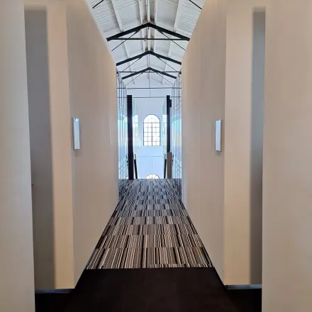 Interior view of a corridor with high ceilings and patterned flooring at Zuidzijde Haven 39a, Bergen op Zoom, ideal for office space rental.