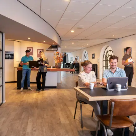 Bright office space at Zuidzijde Haven 39a, Bergen op Zoom featuring professionals collaborating and working on laptops, ideal for office space rental.