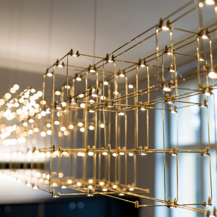 Close-up of intricate gold lighting fixture in an office space at Kurfürstendamm 15, Berlin Charlottenburg, available for office space rental.