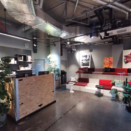 A stylish office space at Koppenstraße 93, Berlin Friedrichshain, featuring modern seating and an open layout with plants and decor, available for rent.