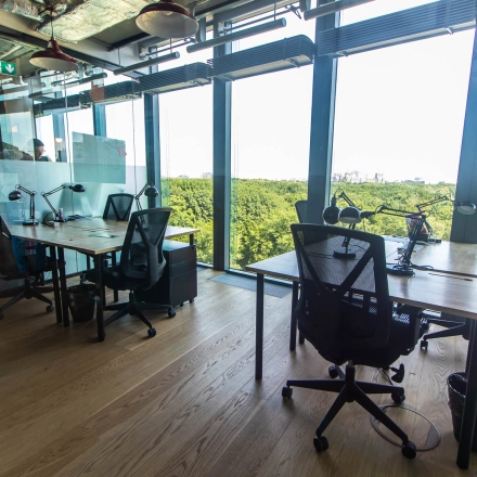 Modern office space rental at Warschauer Platz 11-13, Berlin Friedrichshain, featuring workstations with a stunning view. Ideal for businesses seeking an office to rent.